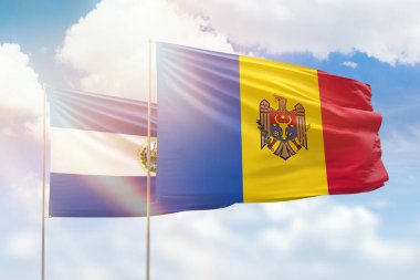 Sunny blue sky and flags of moldova and el salvador