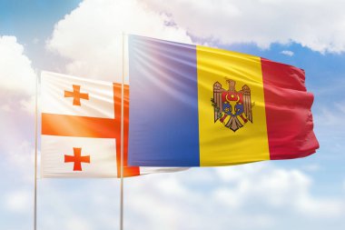 Sunny blue sky and flags of moldova and georgia