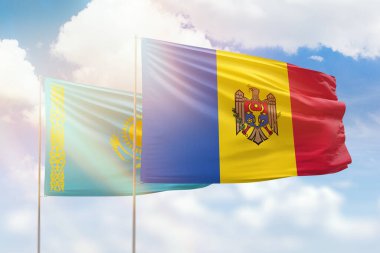 Sunny blue sky and flags of moldova and kazakhstan