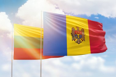Sunny blue sky and flags of moldova and lithuania
