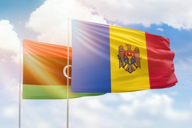 Sunny blue sky and flags of moldova and libya