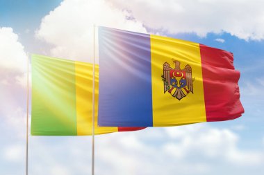 Sunny blue sky and flags of moldova and mali
