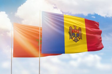 Sunny blue sky and flags of moldova and morocco