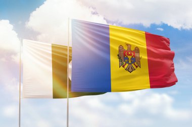 Sunny blue sky and flags of moldova and pakistan