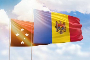 Sunny blue sky and flags of moldova and papua new guinea