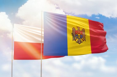 Sunny blue sky and flags of moldova and poland