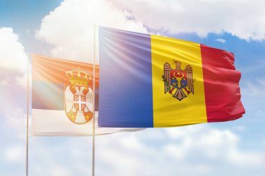 Sunny blue sky and flags of moldova and serbia