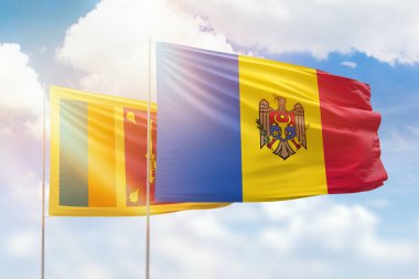 Sunny blue sky and flags of moldova and sri lanka