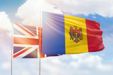 Sunny blue sky and flags of moldova and united kingdom