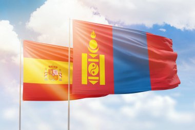 Sunny blue sky and flags of mongolia and spain