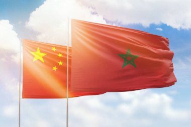 Sunny blue sky and flags of morocco and china