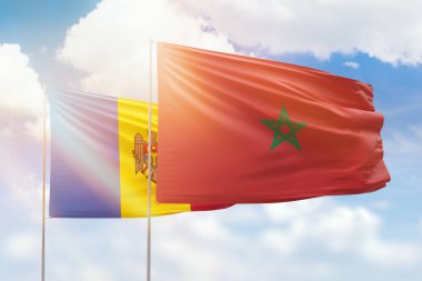 Sunny blue sky and flags of morocco and moldova
