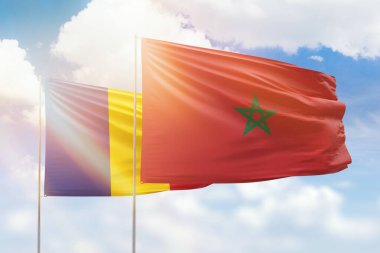 Sunny blue sky and flags of morocco and romania
