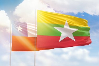 Sunny blue sky and flags of myanmar and chile