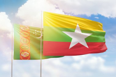 Sunny blue sky and flags of myanmar and turkmenistan