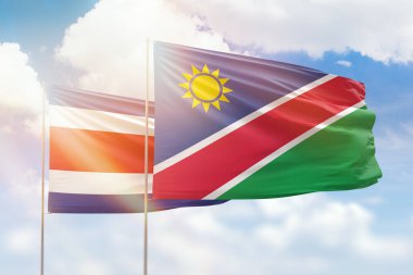 Sunny blue sky and flags of namibia and costa rica