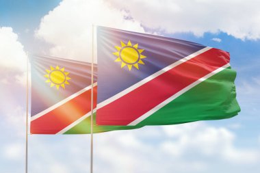 Sunny blue sky and flags of namibia and namibia