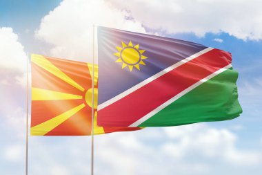 Sunny blue sky and flags of namibia and north macedonia