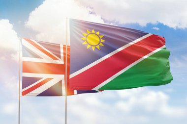 Sunny blue sky and flags of namibia and united kingdom