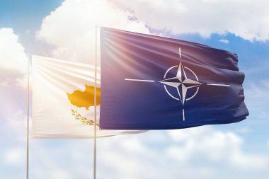 Sunny blue sky and flags of nato and cyprus