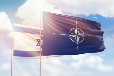 Sunny blue sky and flags of nato and israel