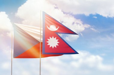 Sunny blue sky and flags of nepal and czechia