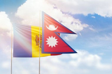 Sunny blue sky and flags of nepal and moldova
