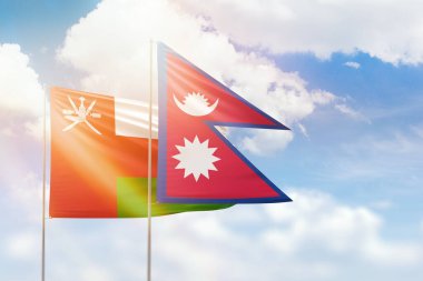 Sunny blue sky and flags of nepal and oman
