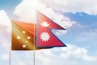 Sunny blue sky and flags of nepal and papua new guinea