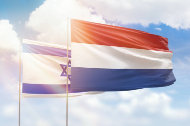 Sunny blue sky and flags of netherlands and israel