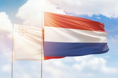 Sunny blue sky and flags of netherlands and malta