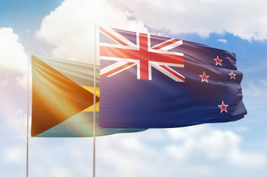 Sunny blue sky and flags of new zealand and bahamas