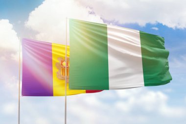 Sunny blue sky and flags of nigeria and andorra