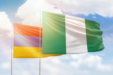 Sunny blue sky and flags of nigeria and armenia