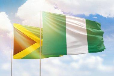 Sunny blue sky and flags of nigeria and jamaica
