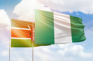 Sunny blue sky and flags of nigeria and kenya
