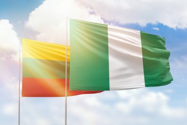 Sunny blue sky and flags of nigeria and lithuania