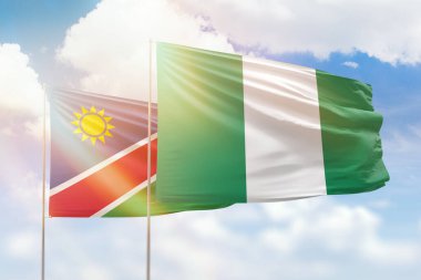 Sunny blue sky and flags of nigeria and namibia