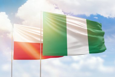 Sunny blue sky and flags of nigeria and poland
