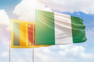 Sunny blue sky and flags of nigeria and sri lanka