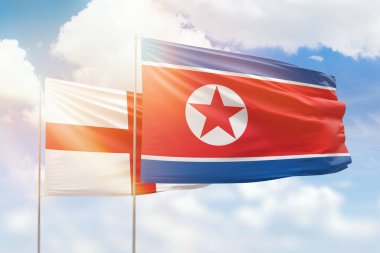 Sunny blue sky and flags of north korea and england