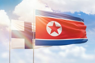 Sunny blue sky and flags of north korea and finland