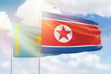 Sunny blue sky and flags of north korea and kazakhstan