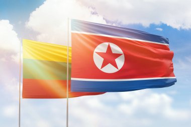 Sunny blue sky and flags of north korea and lithuania