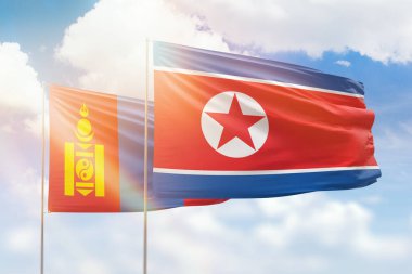 Sunny blue sky and flags of north korea and mongolia
