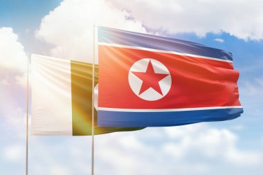 Sunny blue sky and flags of north korea and pakistan