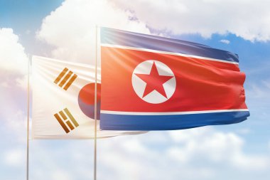 Sunny blue sky and flags of north korea and south korea