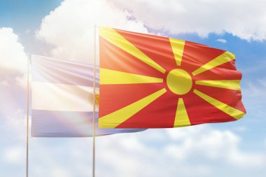 Sunny blue sky and flags of north macedonia and argentina