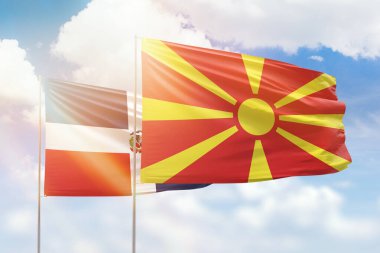 Sunny blue sky and flags of north macedonia and dominican republic