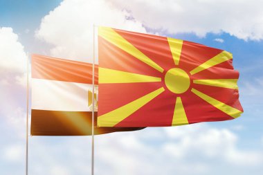 Sunny blue sky and flags of north macedonia and egypt